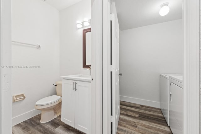 2556 SE 15th Ct, Homestead, FL 33035 - half bathroom featuring toilet, vanity, wood finished floors, washing machine and clothes dryer, and baseboards