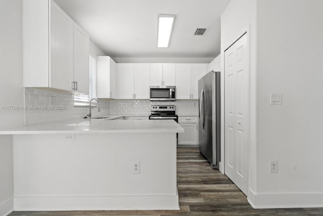 2556 SE 15th Ct, Homestead, FL 33035 - kitchen with light countertops, a sink, visible vents, a peninsula, and appliances with stainless steel finishes
