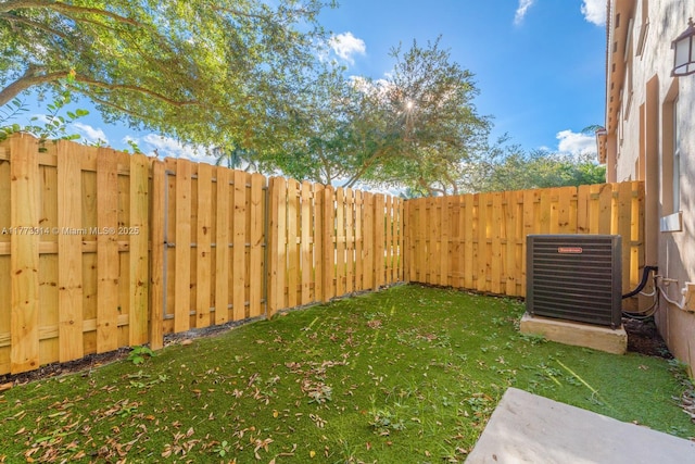 2556 SE 15th Ct, Homestead, FL 33035 - view of yard featuring a fenced backyard and central AC unit