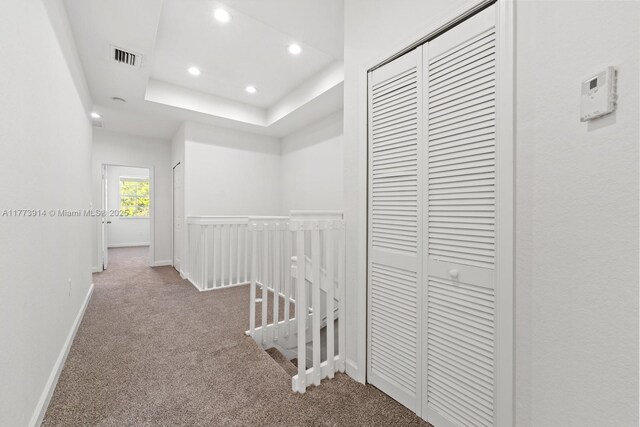 2556 SE 15th Ct, Homestead, FL 33035 - hallway with carpet flooring, an upstairs landing, baseboards, recessed lighting, and a tray ceiling