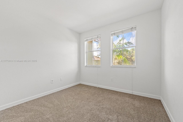 2556 SE 15th Ct, Homestead, FL 33035 - carpeted spare room featuring baseboards