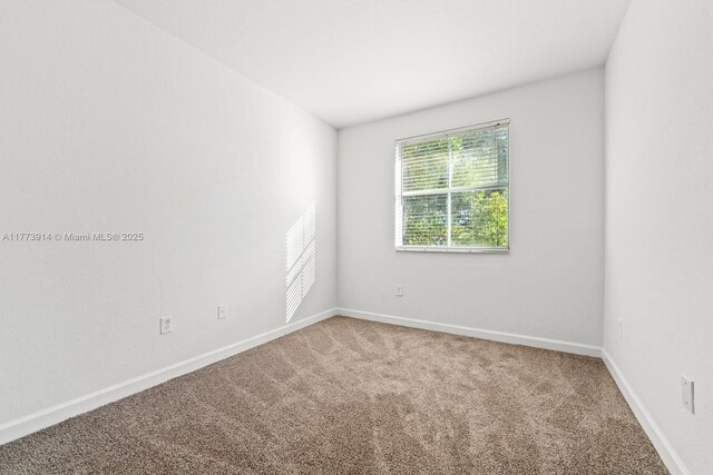 2556 SE 15th Ct, Homestead, FL 33035 - carpeted empty room featuring baseboards