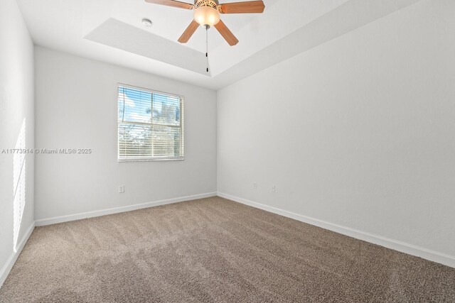 2556 SE 15th Ct, Homestead, FL 33035 - unfurnished room featuring carpet flooring, a raised ceiling, baseboards, and ceiling fan