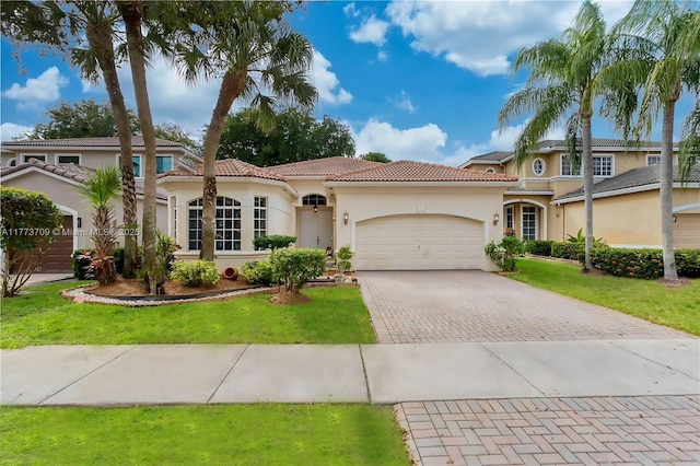 6231 SW 195th Ave, Pembroke Pines, FL 33332 - mediterranean / spanish-style house with decorative driveway, a garage, stucco siding, a tiled roof, and a front lawn