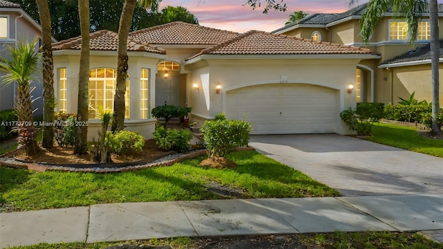 6231 SW 195th Ave, Pembroke Pines, FL 33332 - mediterranean / spanish home featuring a garage, driveway, a tiled roof, and stucco siding