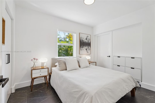 bedroom with baseboards and a closet