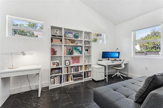 office space with baseboards, marble finish floor, and lofted ceiling