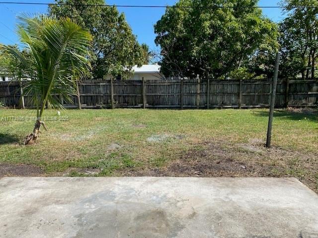 view of yard with fence and a patio