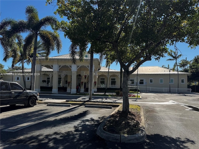view of front of property featuring uncovered parking and a porch