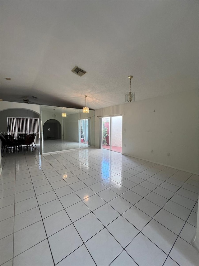 unfurnished room with light tile patterned floors and visible vents