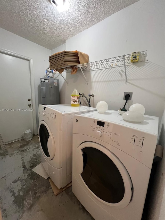 laundry room featuring washing machine and dryer, a textured ceiling, electric water heater, and laundry area