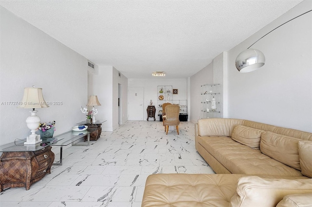300 Bayview Dr Unit 308, Sunny Isles Beach, FL 33160 - living room with a textured ceiling and light marble finish flooring
