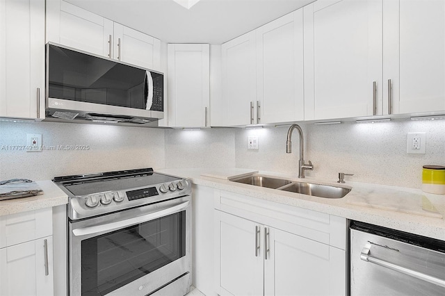 300 Bayview Dr Unit 308, Sunny Isles Beach, FL 33160 - kitchen featuring appliances with stainless steel finishes, decorative backsplash, and white cabinetry