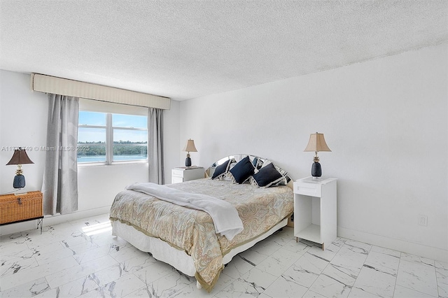 300 Bayview Dr Unit 308, Sunny Isles Beach, FL 33160 - bedroom with light marble finish flooring and a textured ceiling