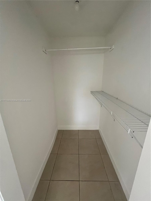 walk in closet featuring tile patterned flooring