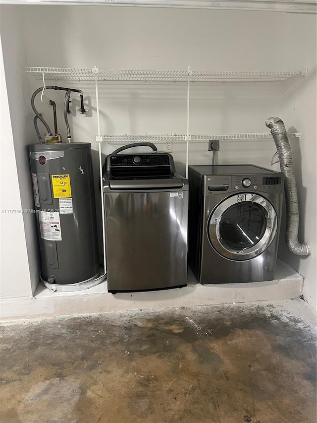 washroom with water heater and washing machine and clothes dryer