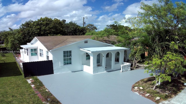 exterior space with driveway, stucco siding, and covered porch