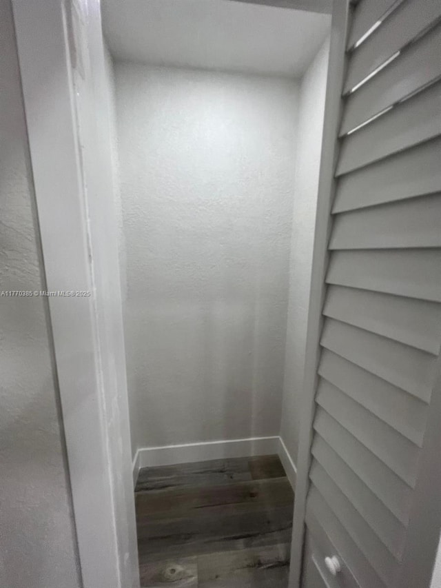 room details featuring baseboards and wood finished floors