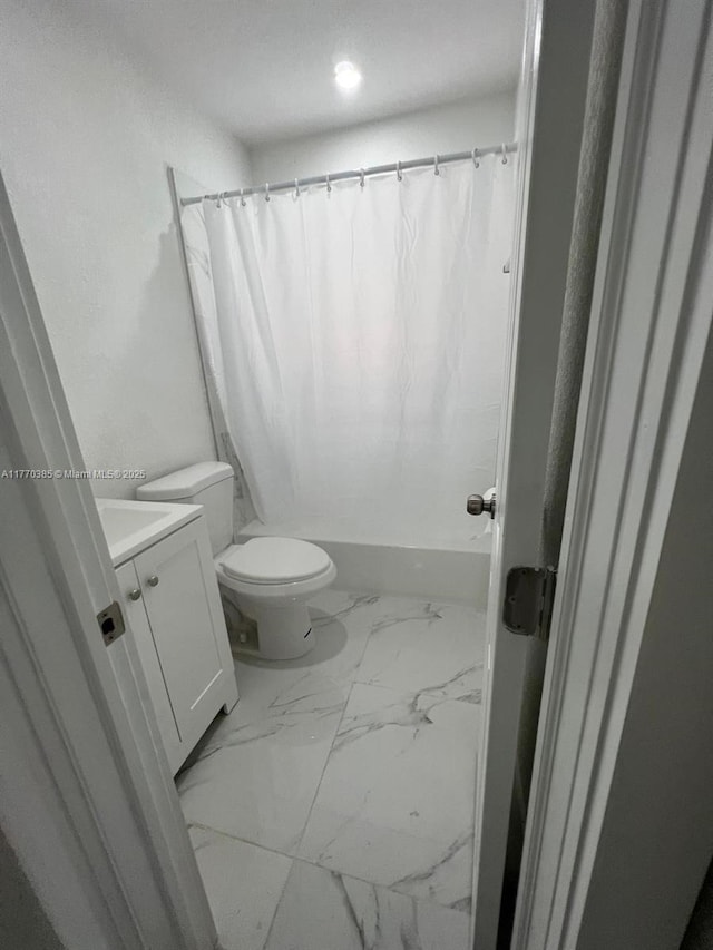 full bath with shower / tub combo with curtain, marble finish floor, toilet, and vanity