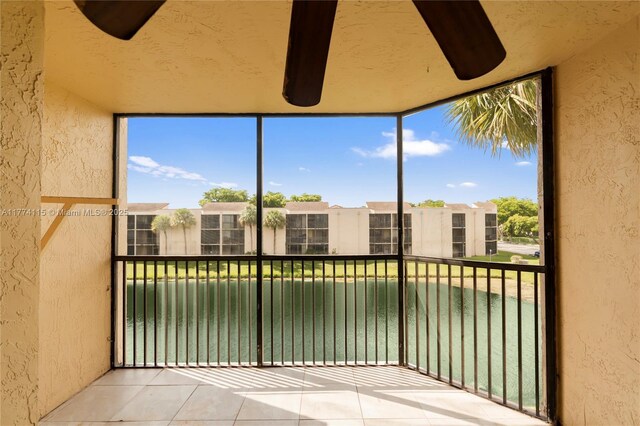 3199 Foxcroft Rd Unit 311, Miramar, FL 33025 - unfurnished sunroom featuring a textured wall, tile patterned flooring, healthy amount of natural light, and a wall of windows