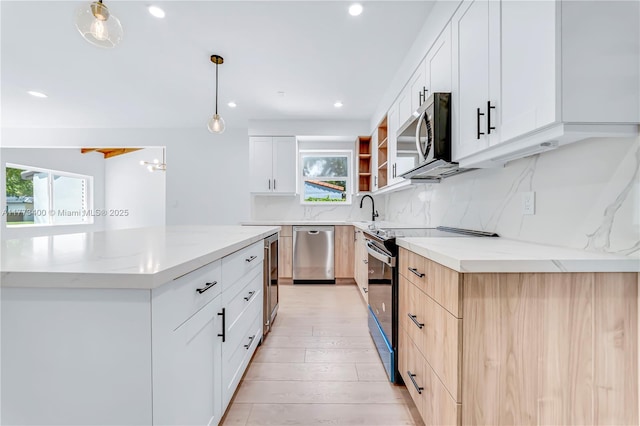 kitchen featuring open shelves, stainless steel appliances, decorative backsplash, a sink, and light stone counters