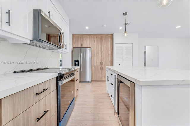 kitchen featuring backsplash, electric range oven, light stone countertops, stainless steel fridge, and beverage cooler