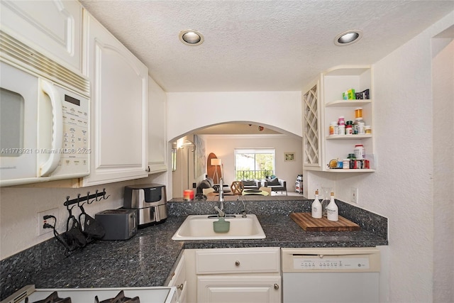 6709 N Kendall Dr Unit 227, Pinecrest, FL 33156 - kitchen with white appliances, a sink, arched walkways, dark countertops, and white cabinetry