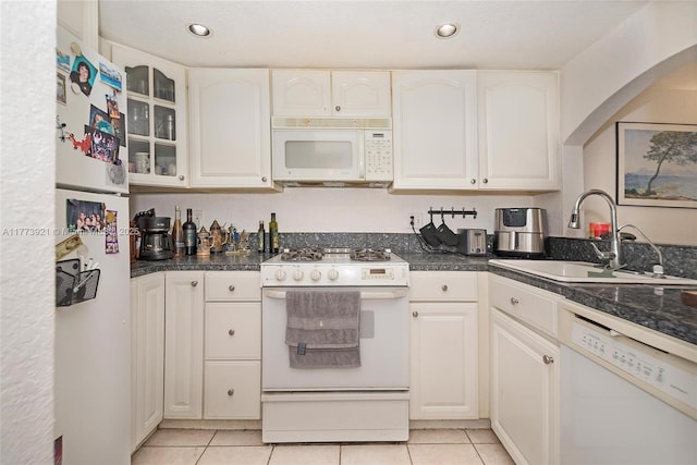 6709 N Kendall Dr Unit 227, Pinecrest, FL 33156 - kitchen with white appliances, a sink, light tile patterned flooring, arched walkways, and white cabinetry