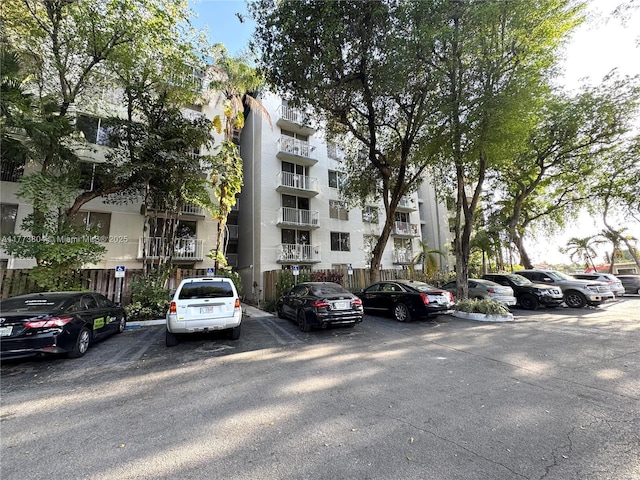 view of building exterior featuring uncovered parking