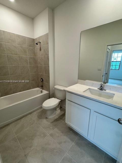 full bath featuring tile patterned floors, toilet, vanity, and shower / bathtub combination