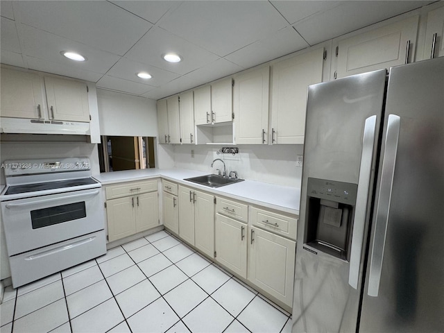 505 NW 177th St Unit 103, Miami Gardens, FL 33169 - kitchen featuring light countertops, a sink, stainless steel fridge, white range with electric stovetop, and under cabinet range hood