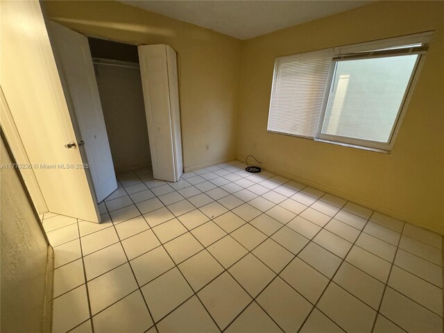 505 NW 177th St Unit 103, Miami Gardens, FL 33169 - unfurnished bedroom with light tile patterned floors and a closet