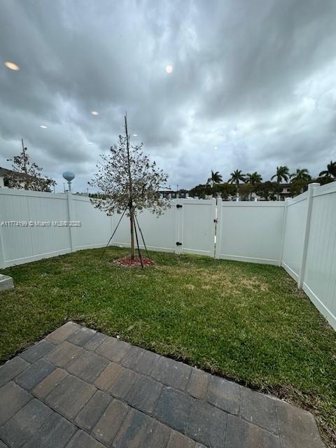 view of yard featuring a patio and a fenced backyard