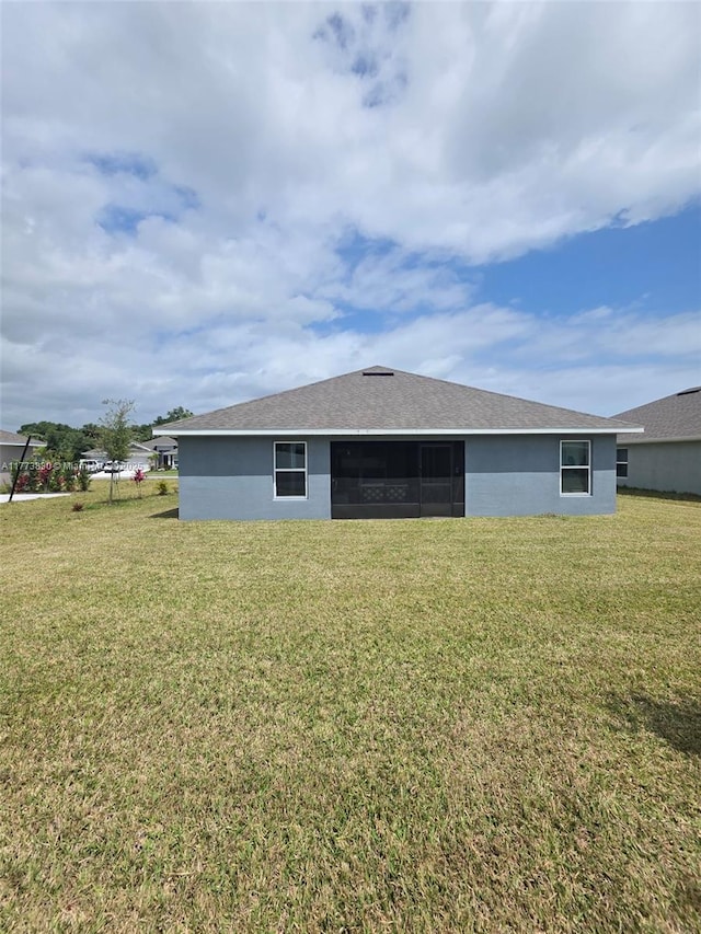 5317 Lugo St, Fort Pierce, FL 34951 - rear view of property with stucco siding and a lawn