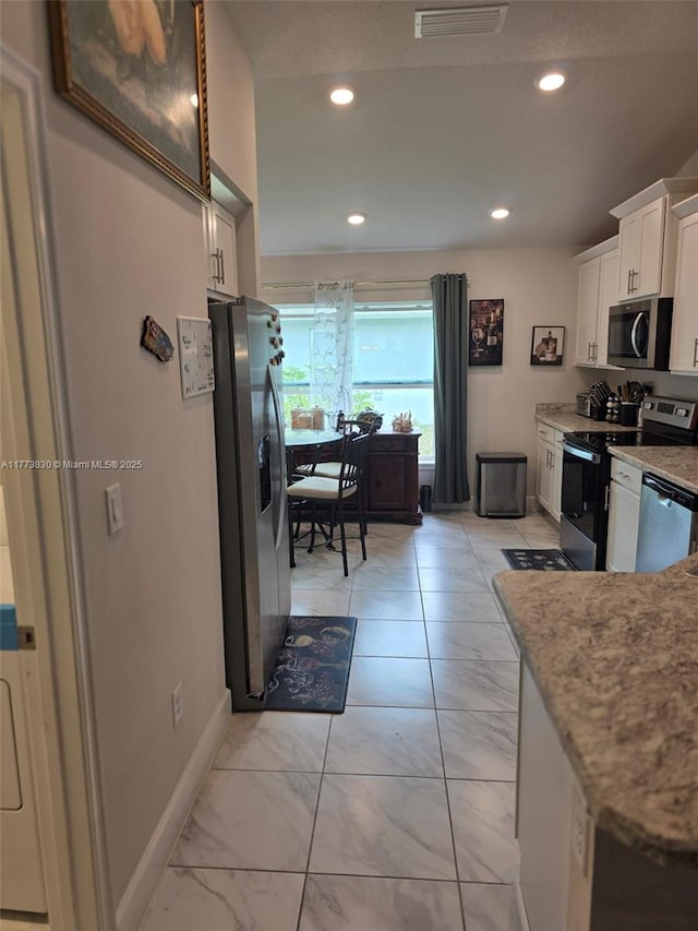 5317 Lugo St, Fort Pierce, FL 34951 - kitchen featuring white cabinets, marble finish floor, appliances with stainless steel finishes, and recessed lighting