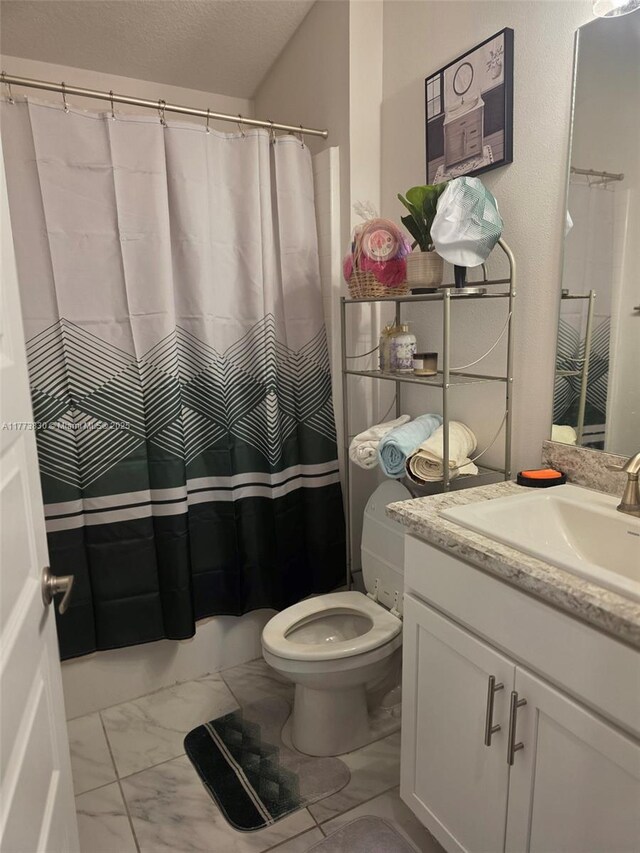 5317 Lugo St, Fort Pierce, FL 34951 - full bathroom featuring marble finish floor, vanity, toilet, and a textured ceiling