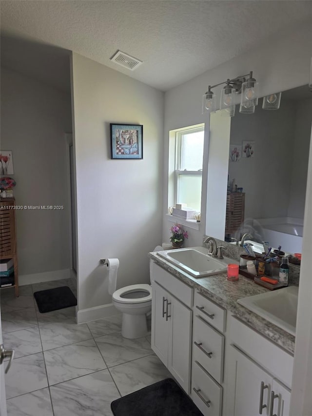 5317 Lugo St, Fort Pierce, FL 34951 - bathroom featuring marble finish floor, visible vents, a sink, and a textured ceiling