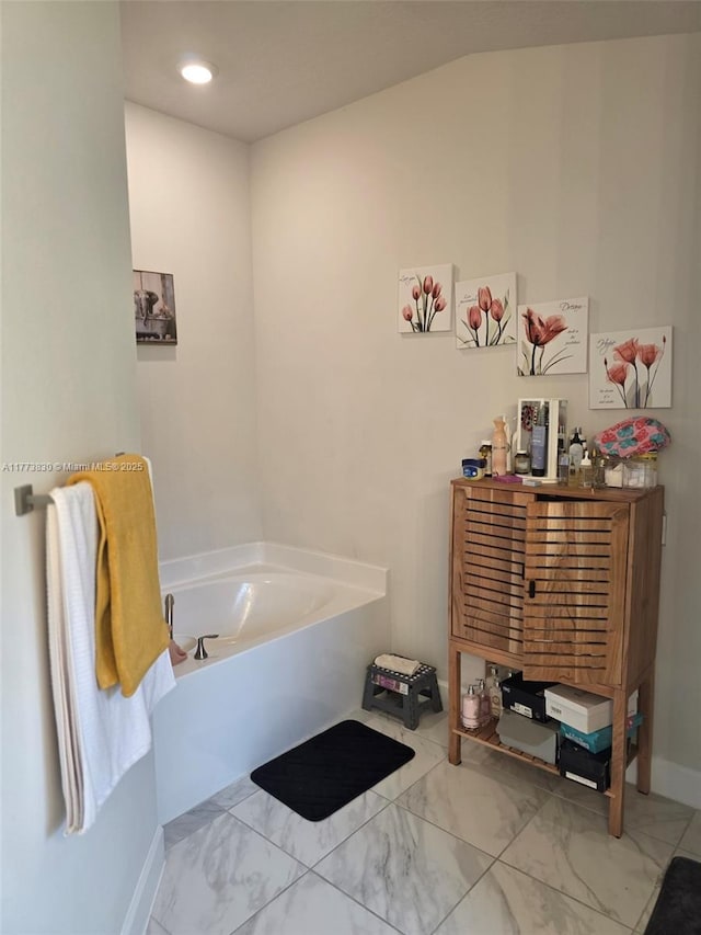 5317 Lugo St, Fort Pierce, FL 34951 - bathroom featuring baseboards, marble finish floor, and a garden tub