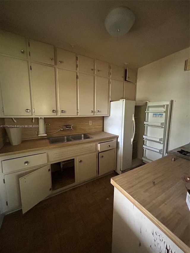 3401 SW 14th St, Miami, FL 33145 - kitchen with freestanding refrigerator, a sink, white cabinets, light countertops, and tasteful backsplash
