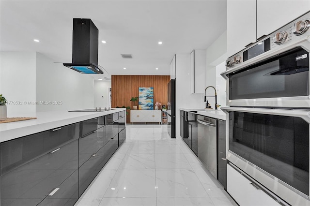 1446 Scott St, Hollywood, FL 33020 - kitchen featuring exhaust hood, visible vents, appliances with stainless steel finishes, modern cabinets, and marble finish floor