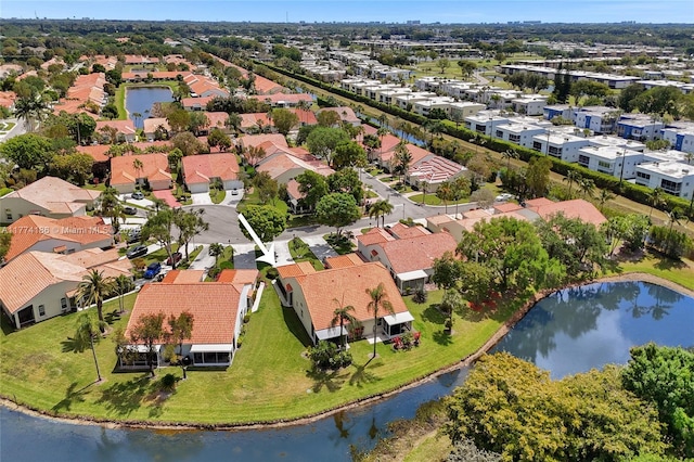 drone / aerial view with a water view and a residential view