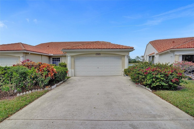 view of front of house featuring a garage, stucco siding, a tiled roof, and concrete driveway
