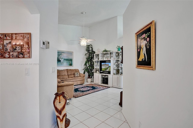 living room featuring light tile patterned floors and a ceiling fan