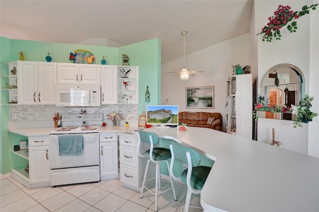 kitchen featuring tasteful backsplash, light countertops, open shelves, and white appliances