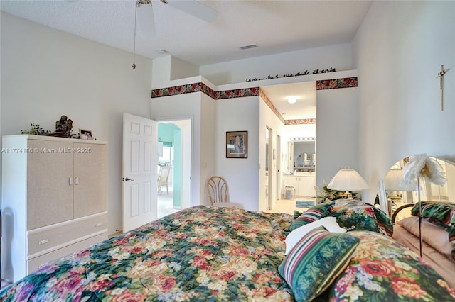 bedroom with visible vents, a ceiling fan, connected bathroom, and lofted ceiling