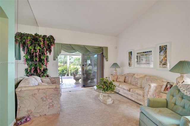 carpeted living room with lofted ceiling