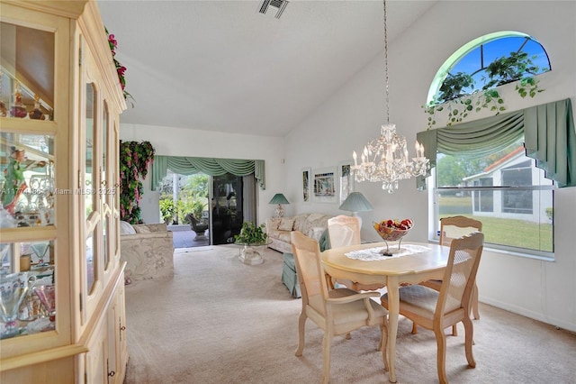 dining area featuring high vaulted ceiling, a notable chandelier, light colored carpet, and visible vents