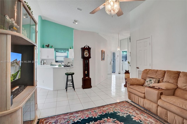 living room with light tile patterned floors, ceiling fan, high vaulted ceiling, and visible vents
