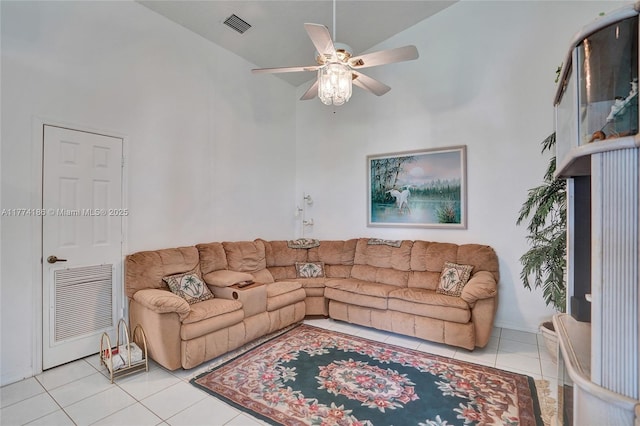 living room featuring tile patterned floors, a high ceiling, ceiling fan, and visible vents