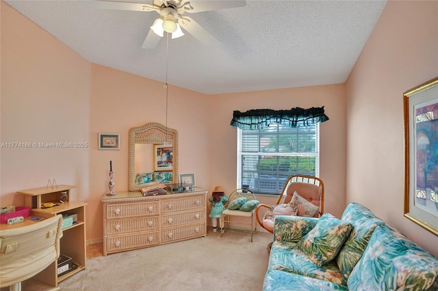 carpeted bedroom with a textured ceiling and a ceiling fan
